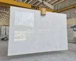 Large Bianco Limestone slab lifted by crane in the MGT factory