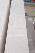 Polished Bianco Limestone tile standing on edge showing the white face