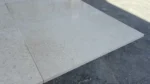 Marva Limestone tile in sunlight showing its fine-grained surface and sawn edge